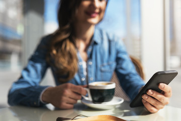 Close up of beautiful woman using her mobile.
