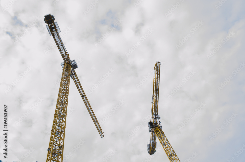 Wall mural looking up at 2 large cranes