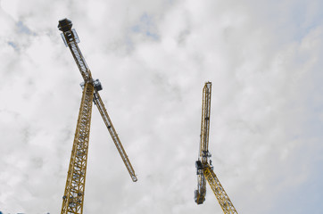 looking up at 2 large cranes