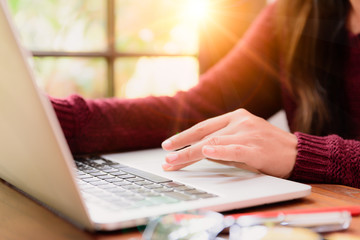 Fototapeta premium Soft focus Closeup woman hand working on her laptop. Social networking technology concept.