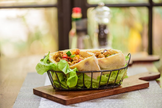 Pork and Chicken Curry Roti naan bread wraps at indian food restaurant.