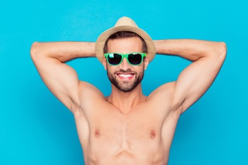 Attractive, cheerful, manly, stunning, funny man in glasses and hat holding hands behind the head,...