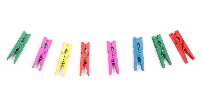 Colorful wooden clothespins isolated on white background, top view