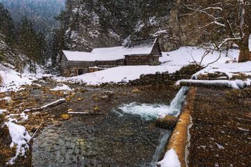 Old wooden water mill in winter with snow falling © Nick Fox