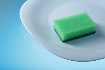 White dish and sponge for dishes .