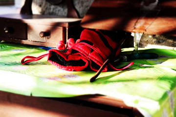 A red work gloves on the wooden table