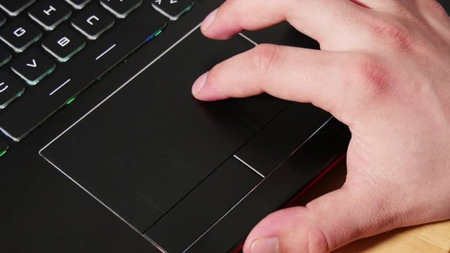 Close up of  hand touching a touchpad on laptop