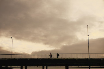 Silhouette person on the bridge with street lanterns