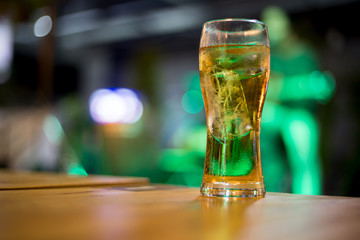 The liquor in the glass is on the table.