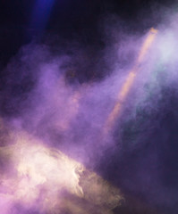 Multi-colored smoke at the concert at night