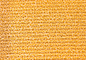 Drops of water on orange plastic as background