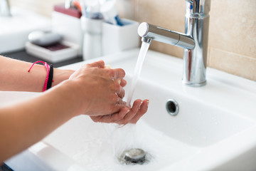 Beautiful young girl washing hands