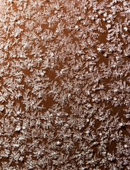 A snowflake on a brown fence as a background