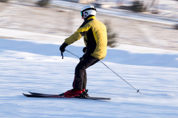 Fototapeta na wymiar A man skiing in a ski resort