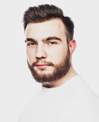 Fototapeta premium Portrait of a young bearded man in a white T-shirt