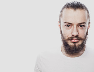 Obraz premium Portrait of a young bearded man in a white T-shirt
