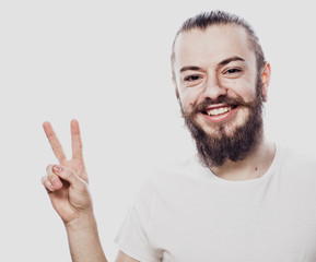 happy bearded man making the victory or peace hand sign on white background