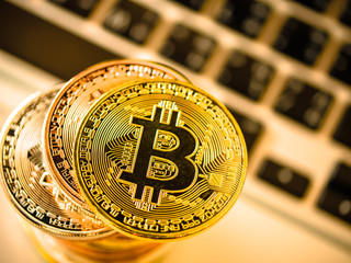 Bitcoin on blurred laptop. Virtual currency wallet bitcoin gold tower and printed encrypted money with qr code cryptocurrency.Digital money concept.