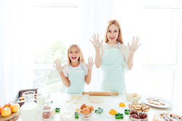 Chef apron friendship friends relationship two people fun-time event play game maternity concept. Pretty mom and cute sweet lovely adorable childish small daughter demonstrating hand smeared in flour