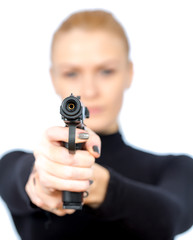 Young blonde woman in a black suit with a gun