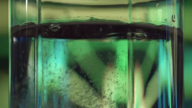 Aspirin in Water. The glass is filled with water. Then in the glass is added effervescent asperin
