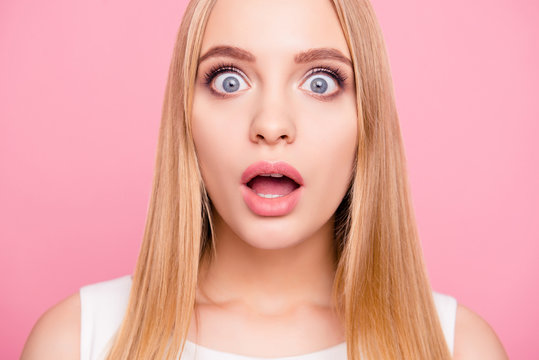 Close up portrait of excited happy smiling cheerful shocked beautiful attractive charming sweet with big gray eyes open mouth blonde long hairdo lady isolated on pink background