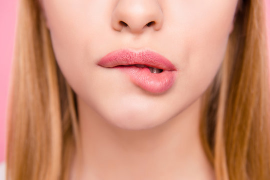 Fillers plump plastic herpes surgery concept. Close up cropped photo of big full natural with lipgloss lips teeth biting lips blonde hair hairstyle isolated on background