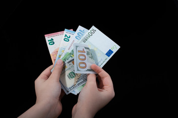 Hand holding American dollar  isolated on black background
