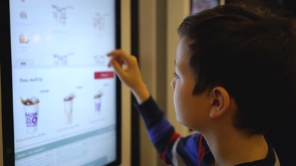 guy makes a purchase of food on the electronic terminal.