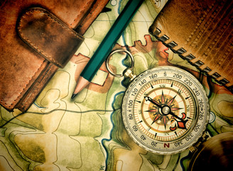 compass wallet and passport on the old map