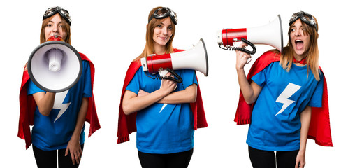Pretty superhero girl shouting by megaphone © luismolinero