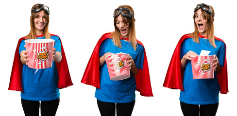 Pretty superhero girl eating popcorns