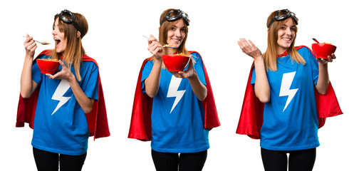 Pretty superhero girl eating cereals from a bowl