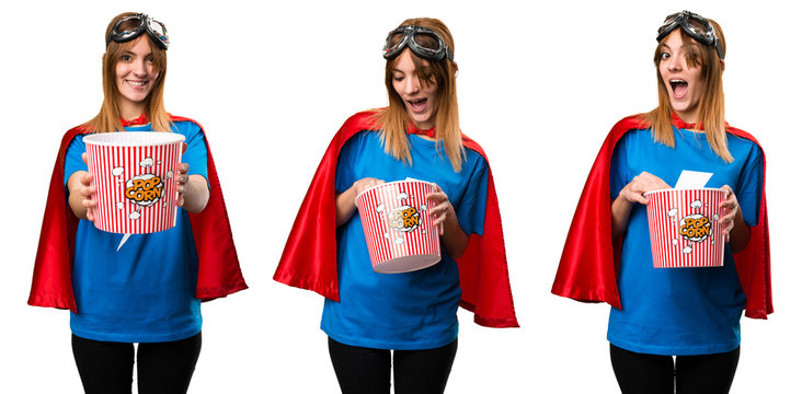 Pretty superhero girl eating popcorns © luismolinero