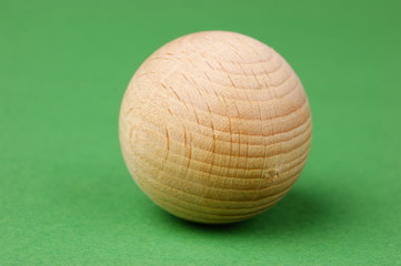 wooden geometric shapes on a green background