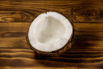 Fototapeta na wymiar Fresh ripe coconut on rustic wooden table