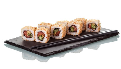 Sushi rolls sprinkled with seeds of sesame and chopsticks, on special stand, isolated on white