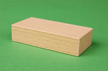 wooden geometric shapes on a green background