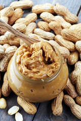 Creamy peanut butter on wood table. Selective focus.