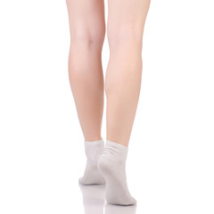 Female legs in white beige cotton socks