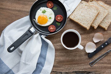 breakfast setting with black coffee and sauaage bacon omelette on the table wooden