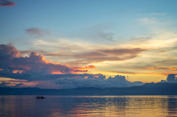 Fototapeta na wymiar Silhouette of a small boat on the ocean at sunset, Cebu island, the Philippines