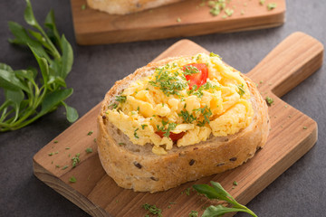 Tasty sandwich with egg and vegetables on old wood block background

