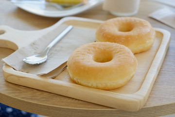 Close up Delicious donuts on wooden plate