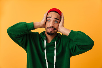 Portrait of a shocked young afro american man in hat