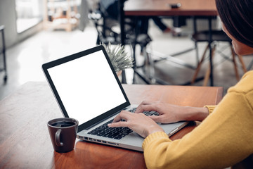 asian woman using laptop computer do online activity on wood table at cafe restaurant.mock up template for display of content.digital lifestyle.