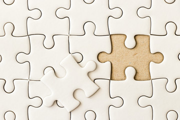 Closed up background of white plain jigsaw wait missing piece to match or fulfill