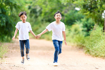 Two boy run in the park