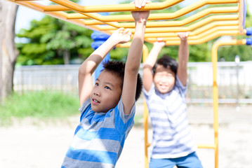 Obraz premium Young asian boy hang out door playground