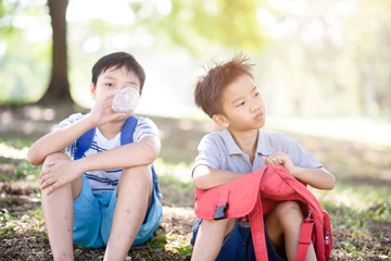 Two boy sit in a park